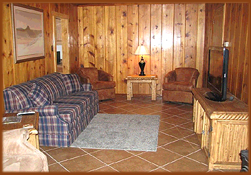 Eagle Nest, NM guest house vacation rental living room view, with paneled walls, flat screen television and DirectTV for all the comforts of home.